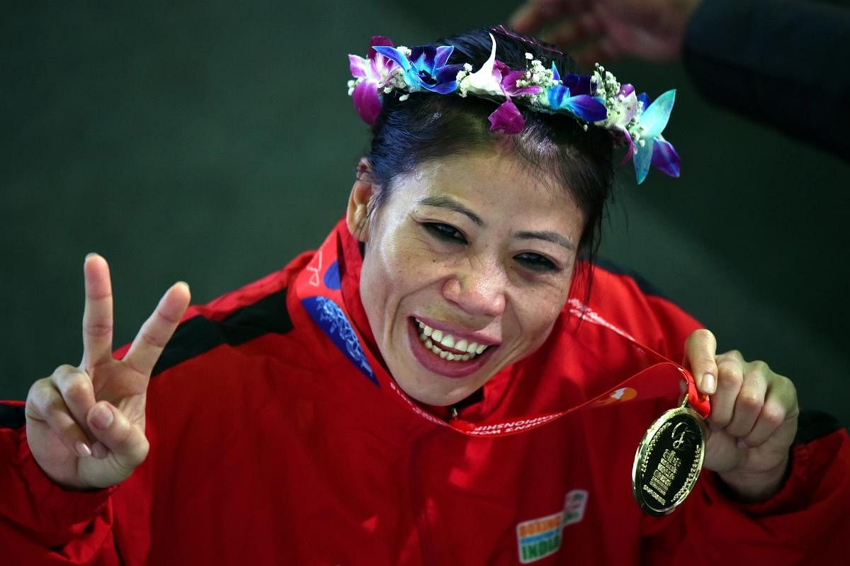 India's Mary Kom celebrates with the gold medal. PTI