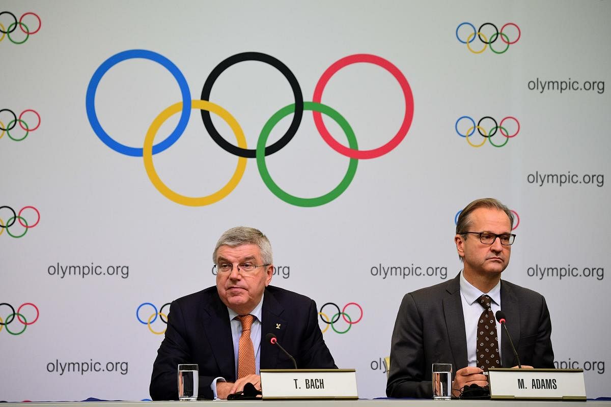 International Olympic Committee (IOC) president Thomas Bach (L) and IOC spokesperson Mark Adams (R) attend a press conference in Tokyo on December 1, 2018. (Photo by Martin BUREAU / AFP)
