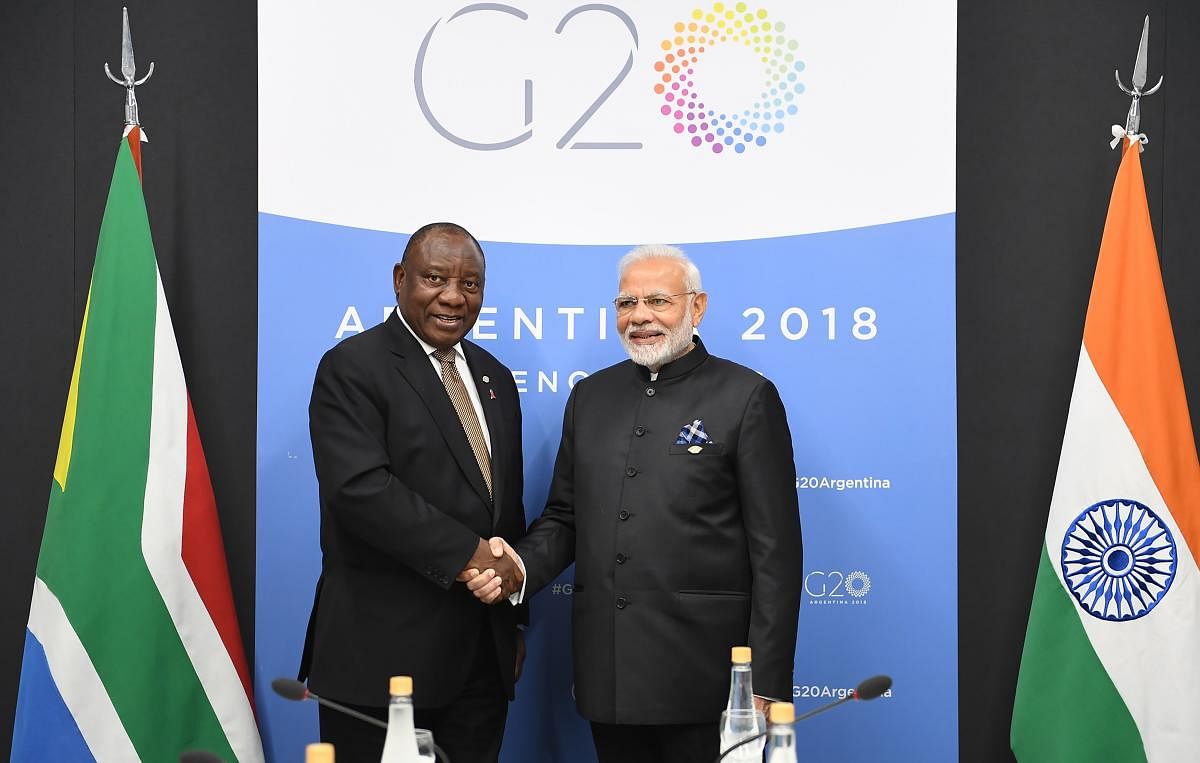 Prime Minister Narendra Modi shakes hands with President of South Africa Cyril Ramaphosa during the G20 Summit, in Argentina's capital Buenos Aires. (AFP Photo/PIB)