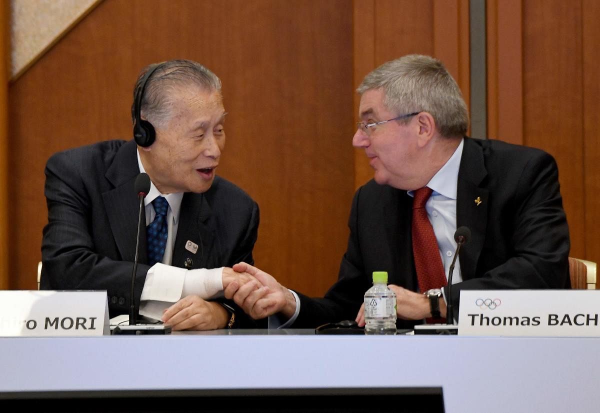 International Olympic Committee (IOC) president Thomas Bach (R) shakes hands with Tokyo 2020 president Yoshiro Mori (L) during the opening plenary session of the IOC Coordination Commission in Tokyo. AFP