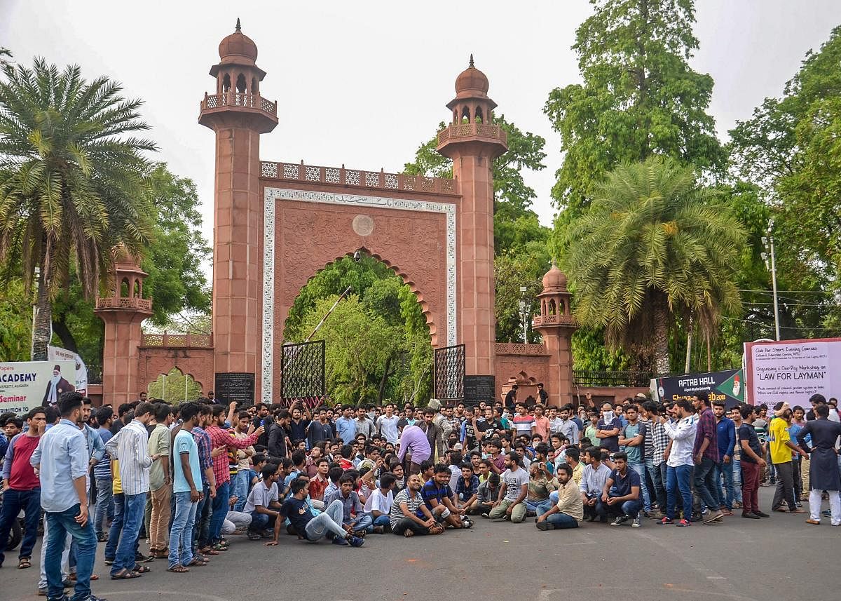 Aligarh Muslim University students protest at the gate of the university campus in Aligarh. (PTI File Photo)