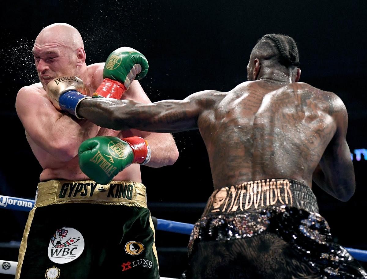 Deontay Wilder lands a punch on Tyson Fury during their WBC Heavyweight title bout in Los Angeles on Saturday. AFP