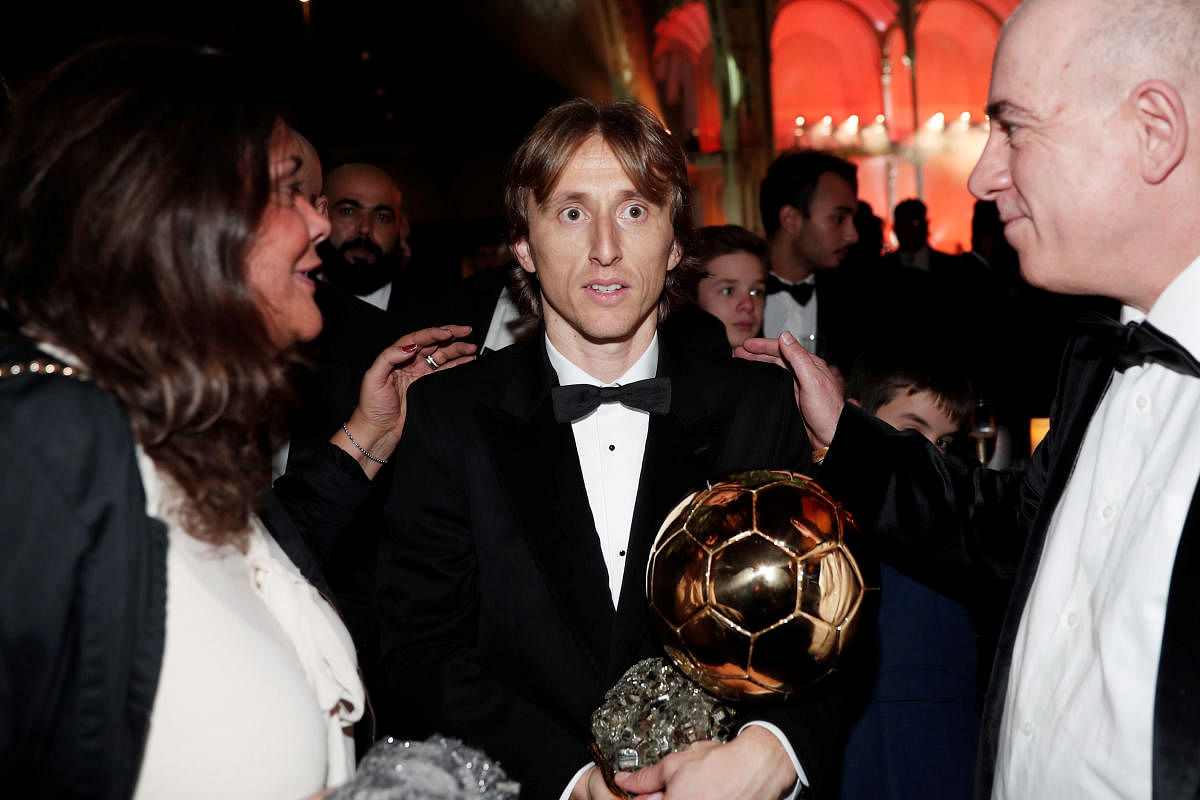 Real Madrid's Luka Modric and the Ballon d'Or award. Reuters