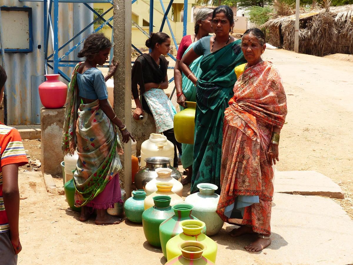 Women waiting to collect fluoridated water from a de-fluoridation plant in Pavagada taluk. Only two to three of the nearly 18 such plants (each installed at a cost of Rs 10.50 lakh) are functioning, according to a study by Team Fluoride. DH PHOTO