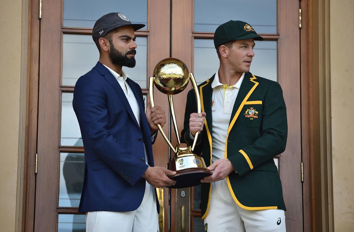 Australia cricket captain Tim Paine (R) and India cricket captain Virat Kohli (L) pose with the Border Gavaskar trophy ahead of the first Test at the Adelaide Oval in Adelaide on December 5, 2018. (AFP Photo)