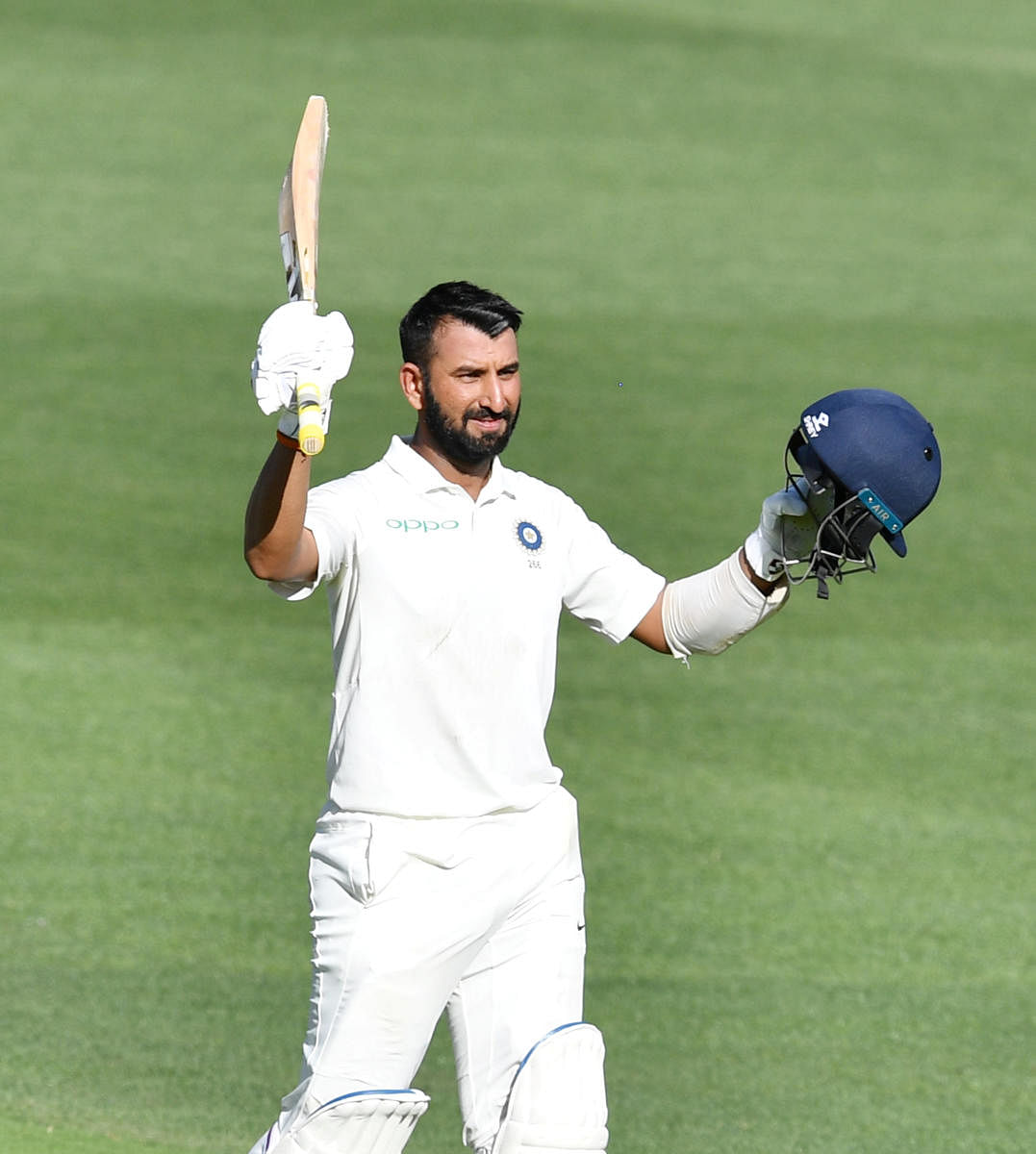 India's Cheteshwar Pujara celebrates after reaching his century against Australia in the first Test in Adelaide on Thursday. Reuters