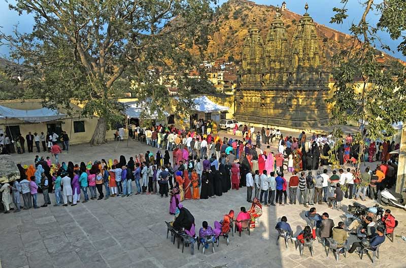 The historic Jaipur city goes to polls. Hundreds of voters casting their franchise in the backdrop of an ancient Shiv temple and Amber Fort. (Photo by Suman Sarkar)