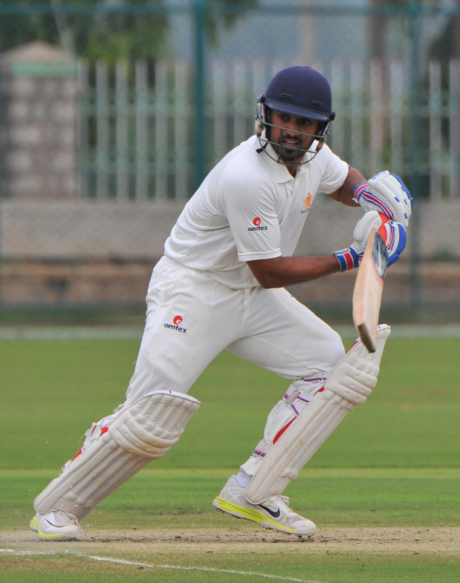 BATTLING: Karnataka's Karun Nair top scored with 63 against Saurashtra on the second day of their Ranji Trophy tie in Rajkot on Friday. DH FILE PHOTO