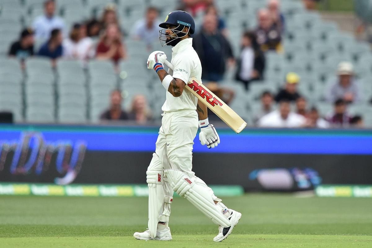 Virat Kohli walks after Australia took his wicket during day three of the first Test cricket match at the Adelaide Oval on December 8, 2018. Credit: AFP Photo/Peter Parks