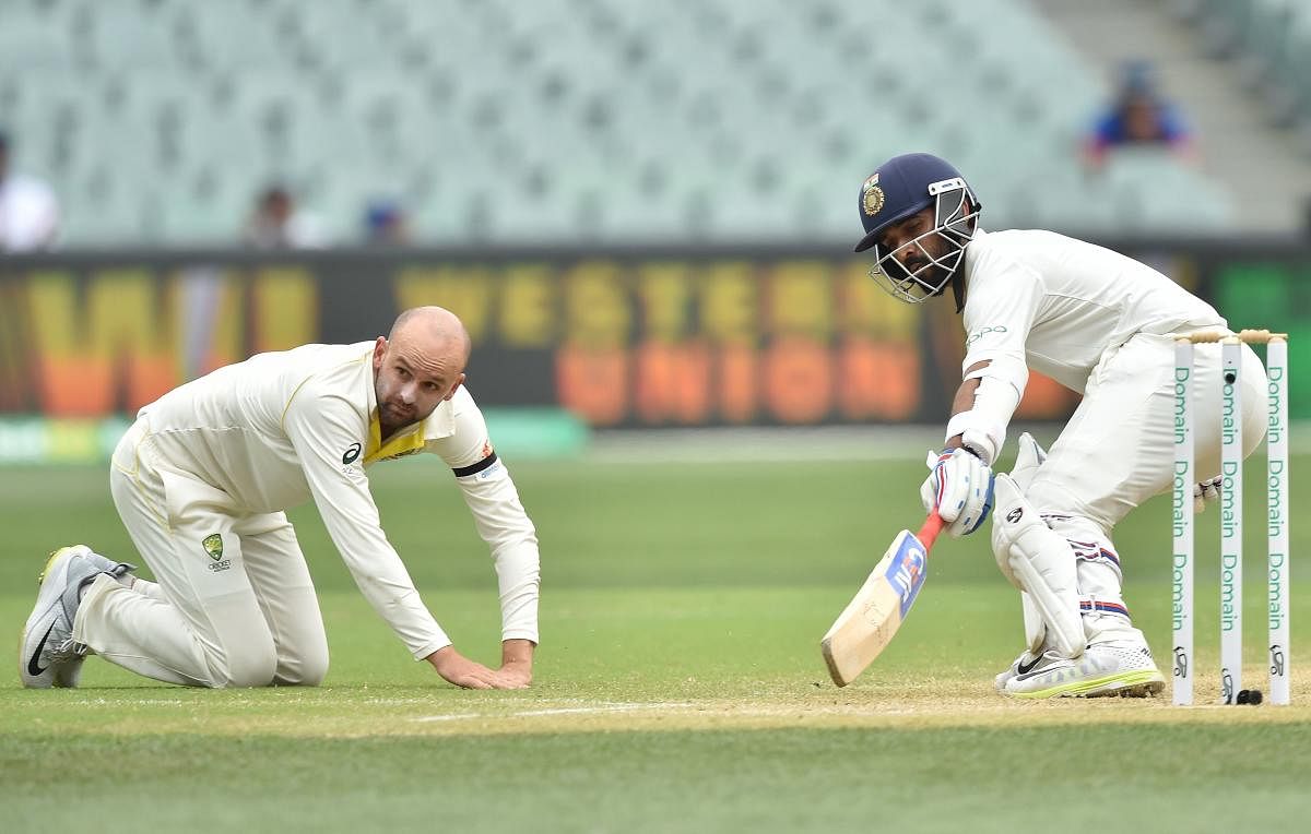 Ajinkya Rahane (R) runs between the wickets as Australia's Nathan Lyon (L) looks on during day four of the first Test cricket match at the Adelaide Oval on December 9, 2018. (AFP Photo) 
