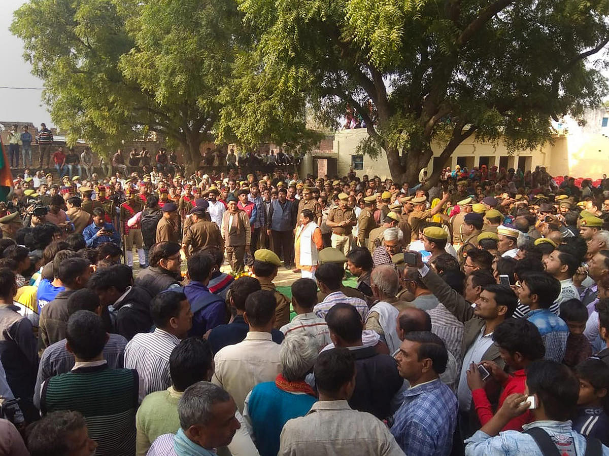 People gather to pay their last respects to Police Inspector Subodh Kumar Singh, during his funeral ceremony in Etah, on December 04, 2018. Singh was killed during violent clashes that erupted over the reported illegal slaughter of cattle, in Bulandshahr.