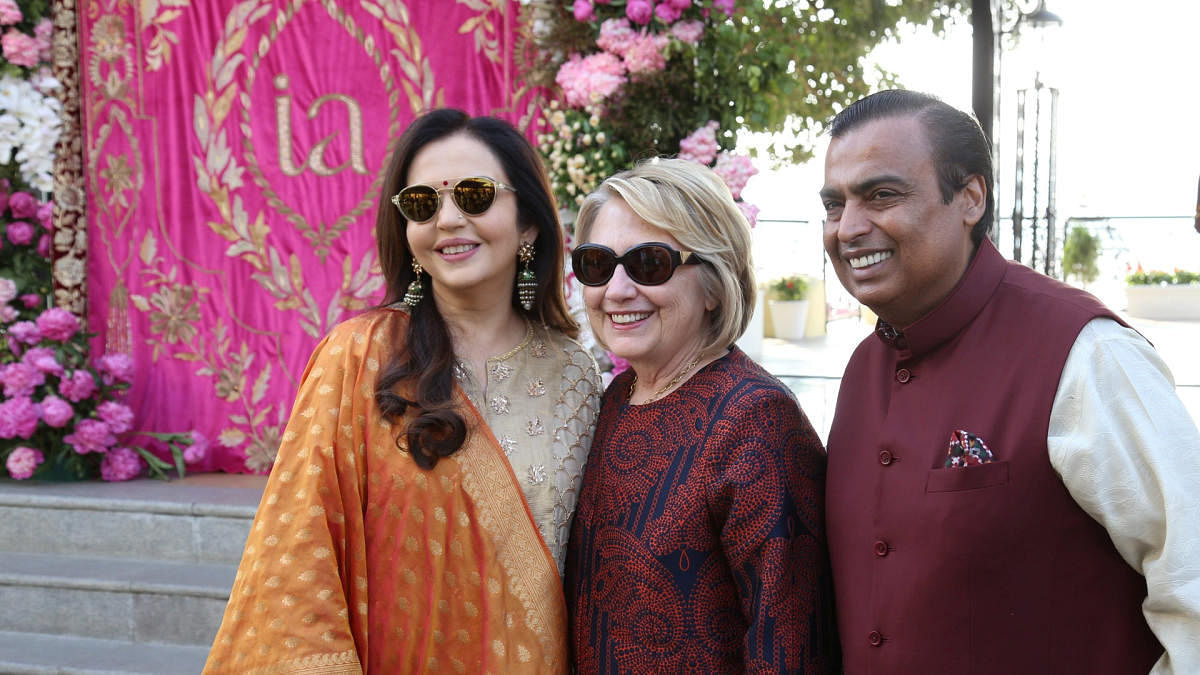 Former U.S. Secretary of State Hillary Clinton poses with Mukesh Ambani, Chairman of Reliance Industries, and his wife Nita Ambani after her arrival in Udaipur to attend pre-wedding celebrations of their daughter Isha Ambani in the desert state of Rajasth