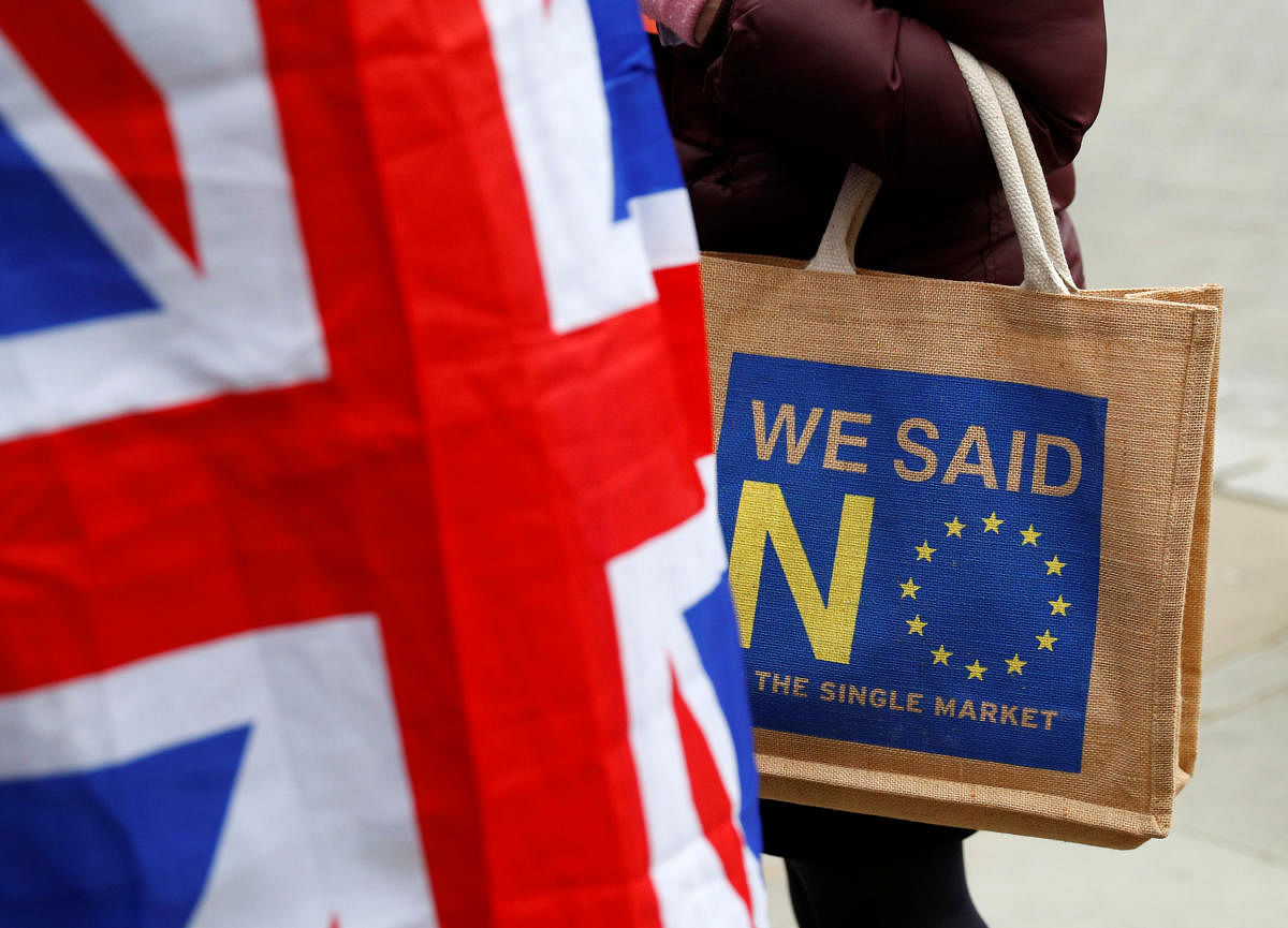 A Brexit supporter carries an anti-EU bag in London, Britain. REUTERS