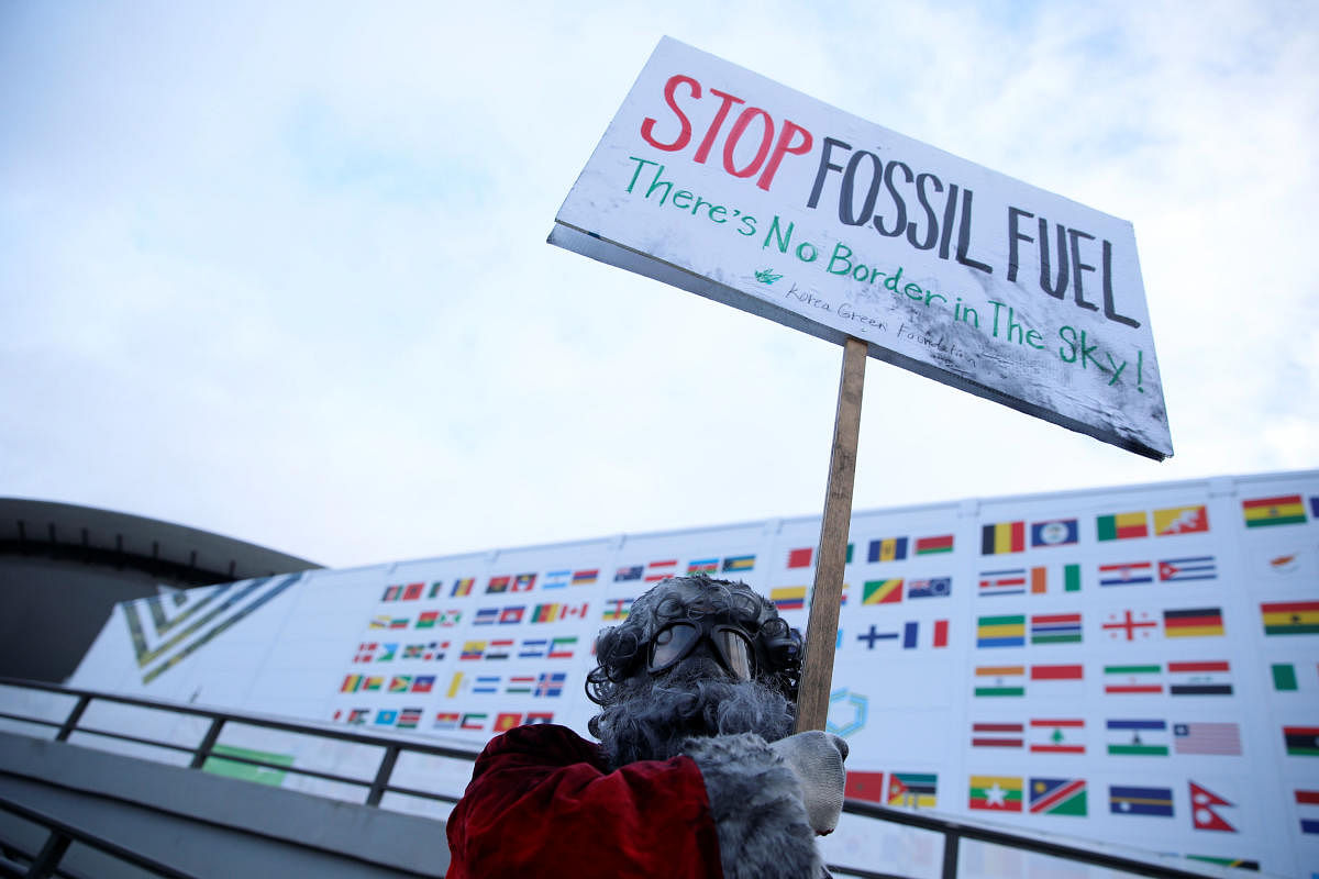 Environmental activist protests against fossil fuel in front of the the venue of the COP24 UN Climate Change Conference 2018 in Katowice, Poland December 10, 2018. Agencja Gazeta/Grzegorz Celejewski via REUTERS ATTENTION EDITORS - THIS IMAGE WAS PROVIDED