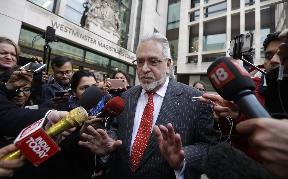 Indian businessman Vijay Mallya is surrounded by the media as he leaves Westminster Magistrates Court in London, Monday, Dec. 10, 2018. A British court has ordered that charismatic Indian tycoon Vijay Mallya should face extradition to India on financial f