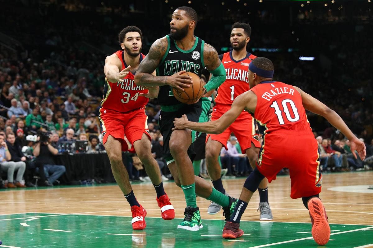 BOSTON, MA - DECEMBER 10: Kenrich Williams #34 of the New Orleans Pelicans and Tim Frazier #10 defend Marcus Morris #13 of the Boston Celtics at TD Garden on December 10, 2018 in Boston, Massachusetts. Maddie Meyer/Getty Images/AFP == FOR NEWSPAPERS, INTE