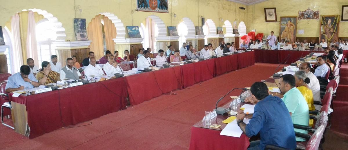 Elected representatives and officials take part in the KDP meeting at the Old Fort Hall in Madikeri on Tuesday.
