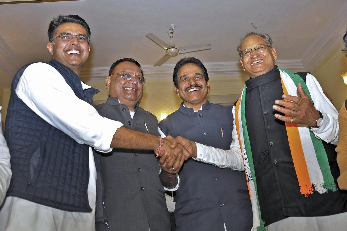 Former Rajasthan chief minister Ashok Gehlot (R), State Congress President Sachin Pilot (L), AICC general secretary KC Venugopal (second R) and Congress incharge for the state Avneesh Pandey greet each other after the party's win in the Assembly elections