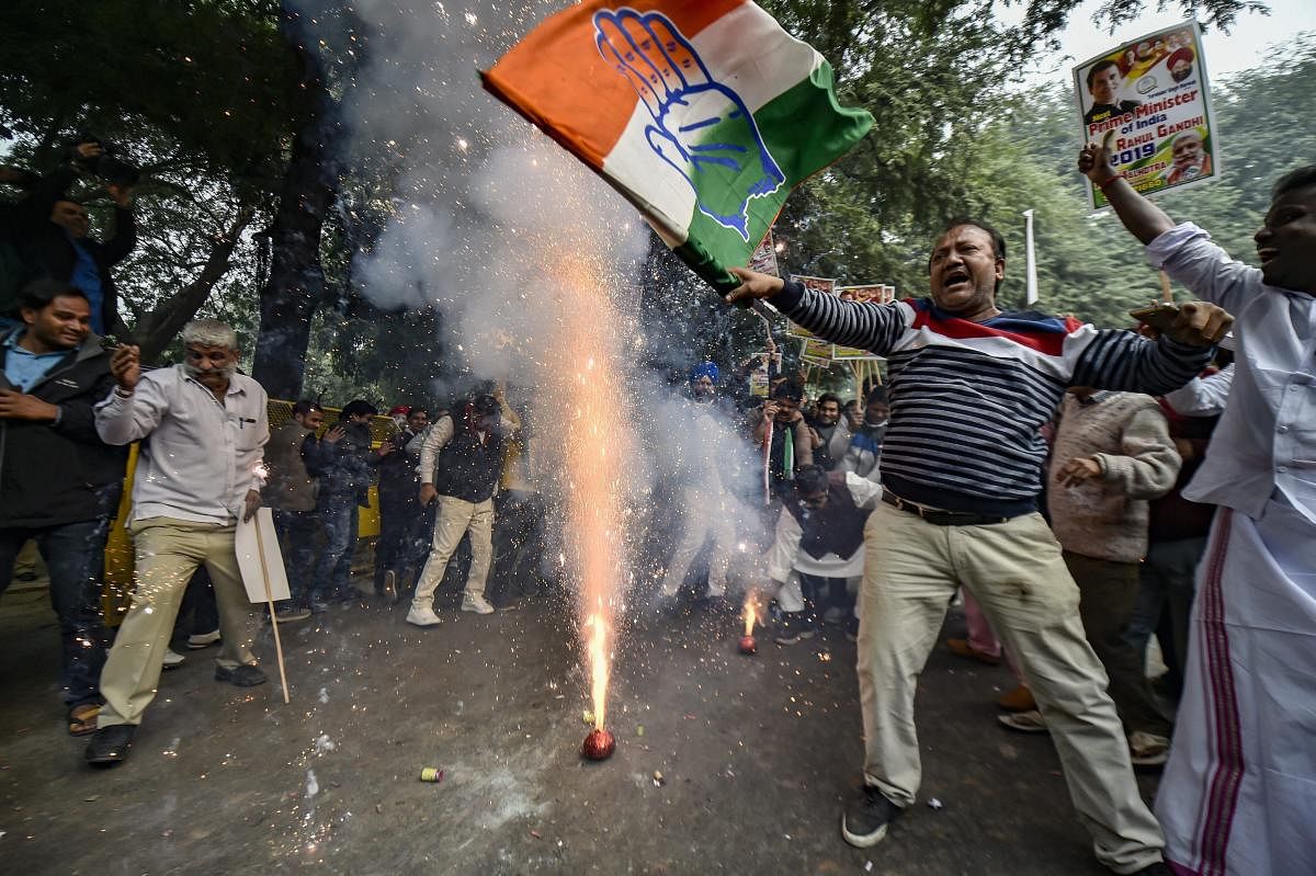 Congress Party workers celebrate as initial trends show the party leading in the states Assembly elections, at the Congress headquarters in New Delhi, Tuesday, Dec.11, 2018. (PTI Photo)