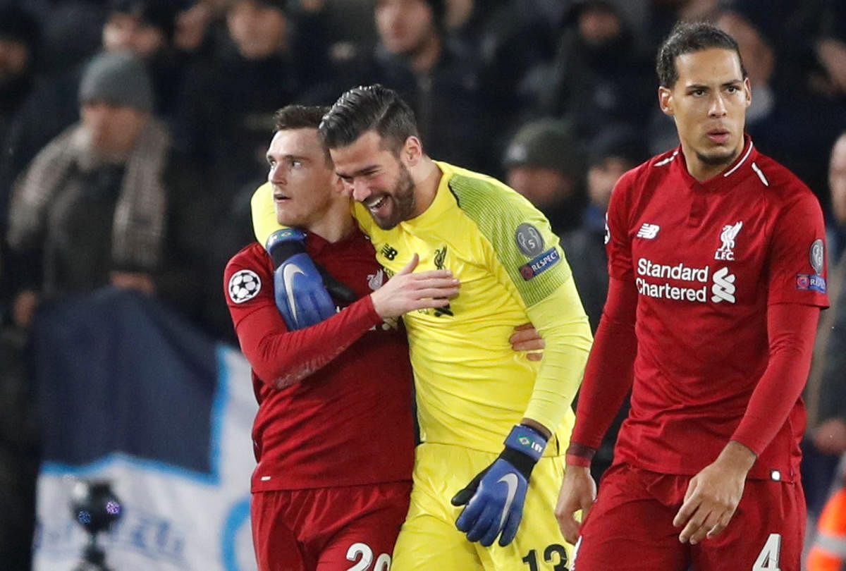 RELIEVED: Liverpool's goalkeeper Alisson celebrates with Andrew Robertson at the end of the match against Napoli. Reuters