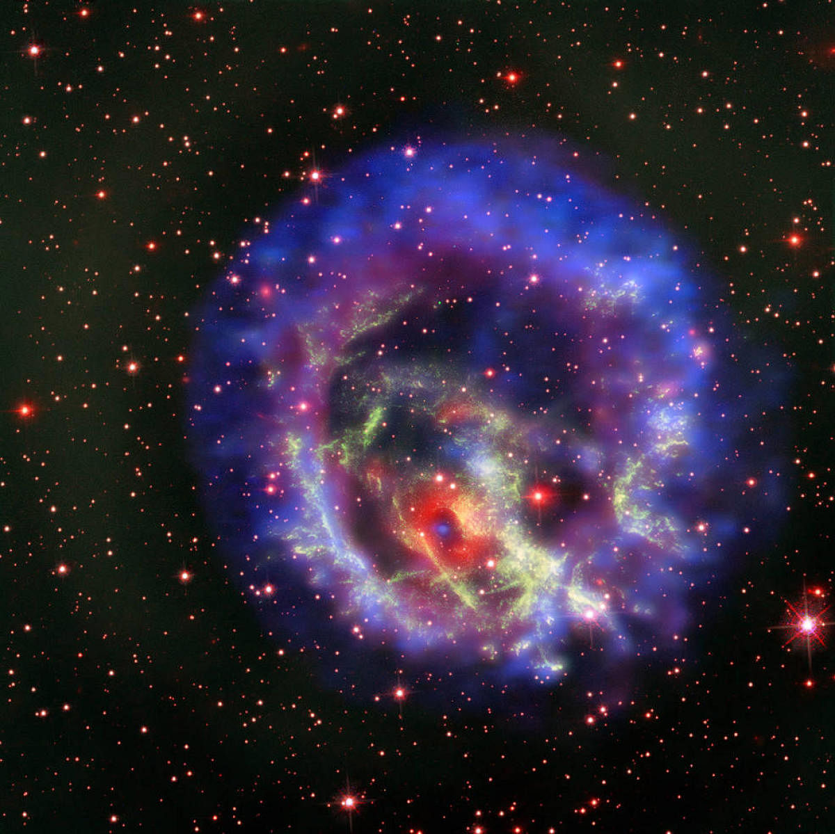 The new composite image of neutron star E0102, released on May 23, combines data from NASA's Chandra X-Ray Observatory (seen in blue and purple), the Multi Unit Spectroscopic Explorer instrument on the European Southern Observatory's Very Large Telescope