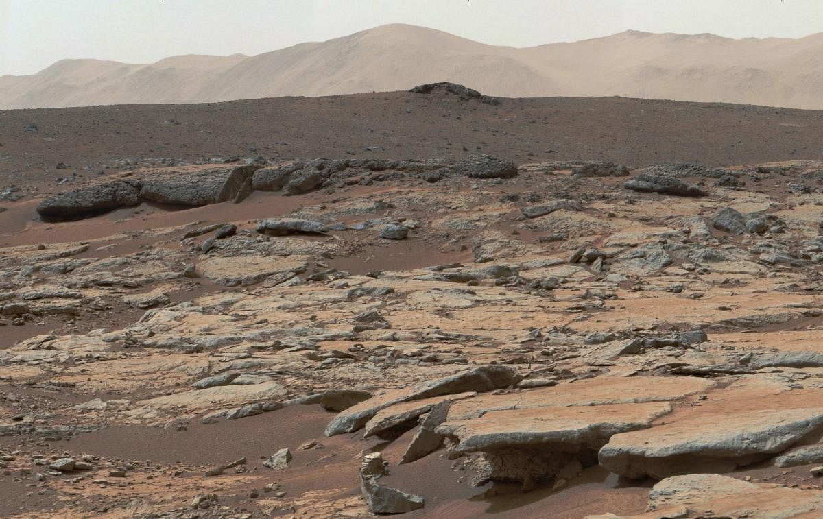 This December 09, 2013, NASA photo is a mosaic of images from NASA's Curiosity Mars rover and shows a series of sedimentary deposits in the Glenelg area of Gale Crater. NASA's rover Curiosity rover tooling around on the surface of Mars has found remnants