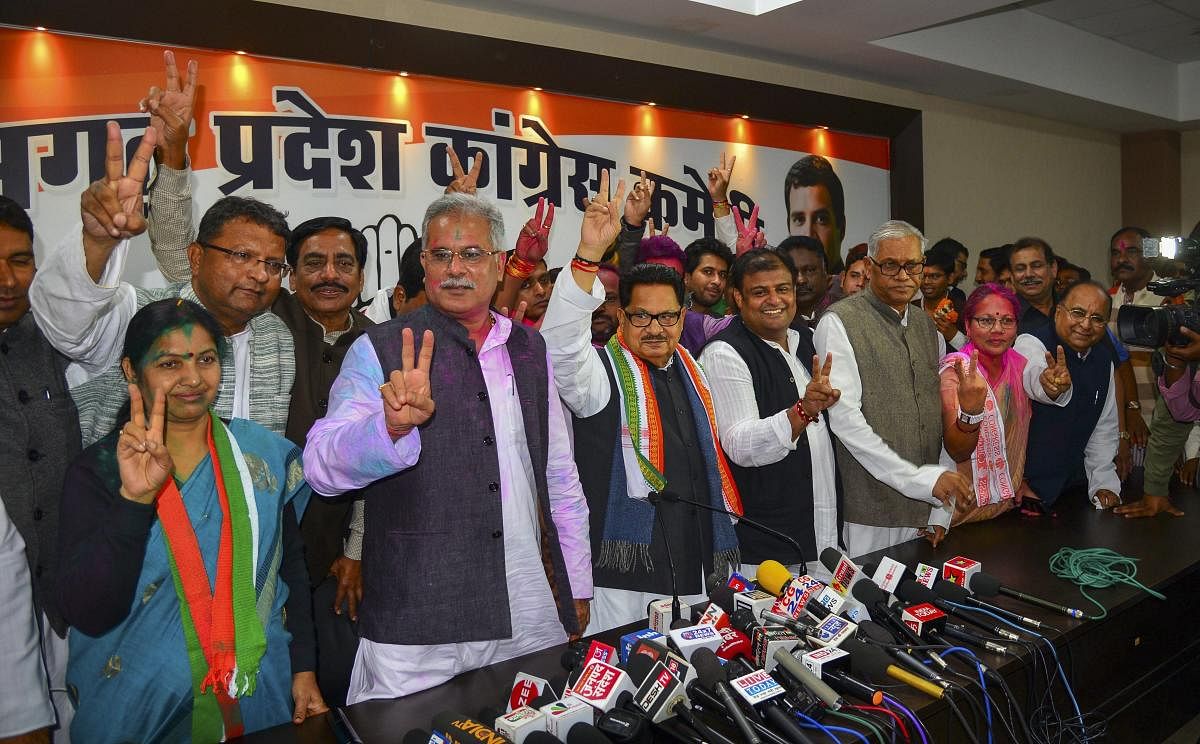 Congress in-charge of Chhattisgarh PL Punia flanked by party leaders display victory sign at a press conference after the party's win in the Assembly elections, in Raipur. PTI Photo