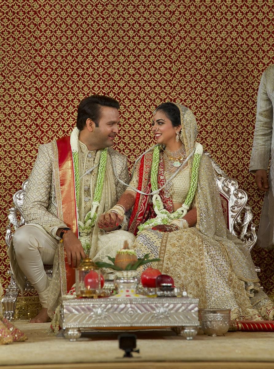 Newlyweds Isha Ambani and Anand Piramal pose for a photograph, in Mumbai, Wednesday. PTI photo