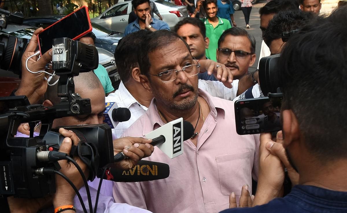 Indian Bollywood actor Nana Patekar is mobbed by the media as he leaves after making a statement outside his home in Mumbai. (AFP photo)