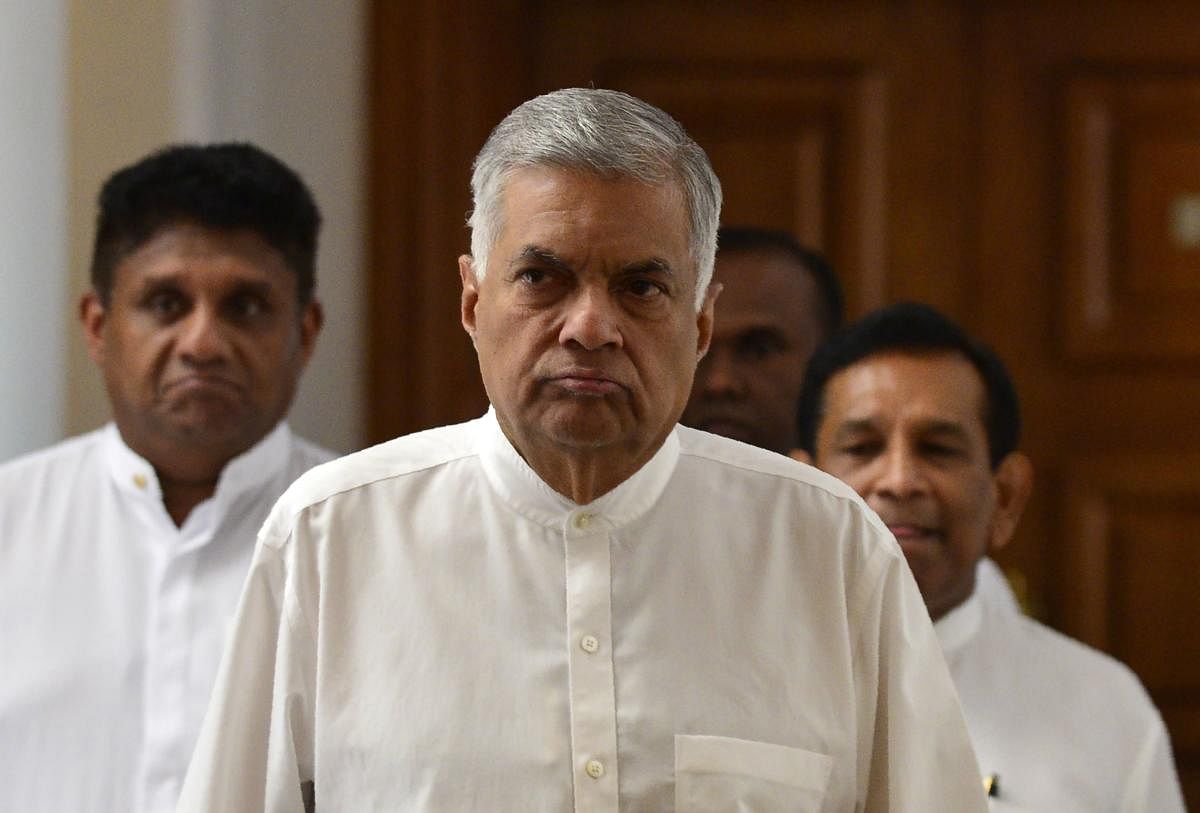 Sri Lanka's ousted prime minister Ranil Wickremesinghe (C) arrives for a press conference in Colombo. AFP Photo