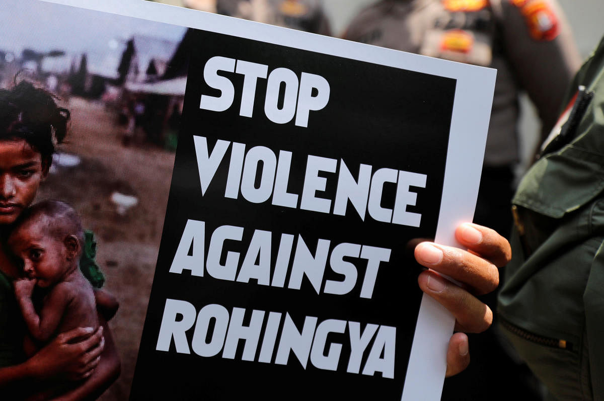 A protester holds a placard during protest against Myanmar's treatment of its Rohingya Muslim minority in front of Myanmar's embassy in Jakarta, Indonesia, December 5, 2018. (REUTERS)