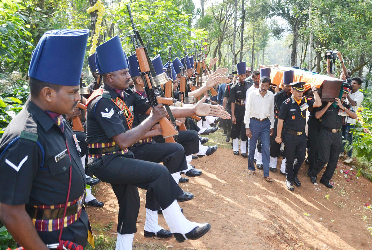 Mortal remains of Lt General (Retd) B C Nanda being carried by military officials to its place of burial in Madikeri, on Thursday.