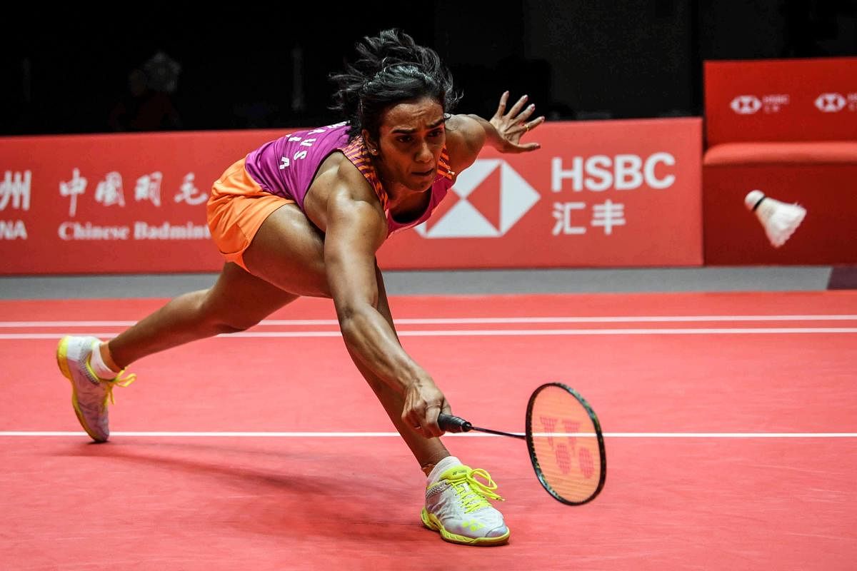 ATHLETIC: India's PV Sindhu returns to Zhang Beiwen of the US during their Group A women's singles game in Guangzhou on Friday. AFP 