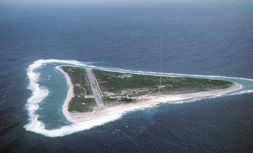 Aerial view of Minamitori Island and the runway that supports the US Coast Guard station located there. | US NAVY / PUBLIC DOMAIN