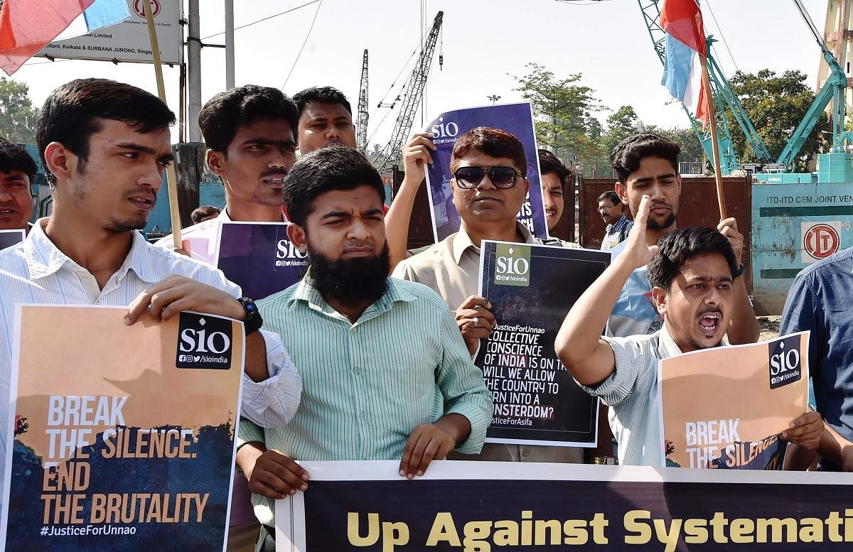 Members of Students Islamic Organisation display posters and shout slogans as they protest over government's alleged 'inaction in Kathua and Unnao rape cases in Kolkata on Sunday. PTI Photo