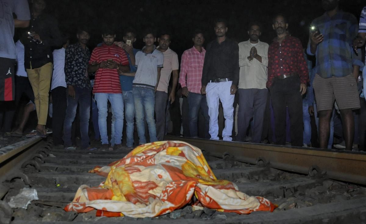 People gather near the body of a victim at the site of a train accident at Joda Phatak in Amritsar, Friday, Oct 19, 2018. Officials said at least 60 bodies have been found and many more injured have been admitted to a government hospital after the accident near the site of Dussehra festivities. (PTI Photo)