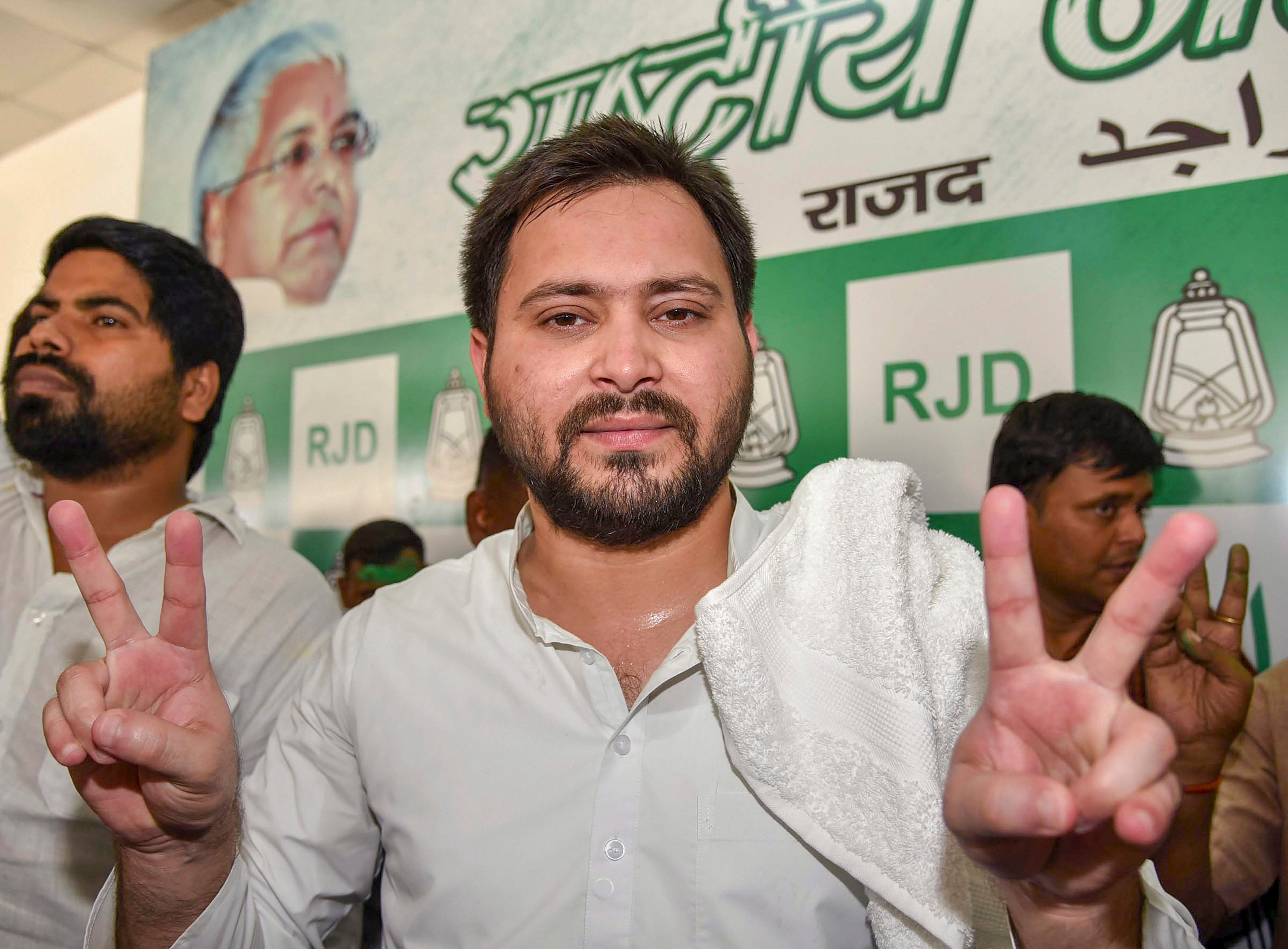 RJD leader Tejaswi Yadav flashes the victory sign after the party's victory in Jokihat Assembly by-polls, in Patna on Thursday. PTI