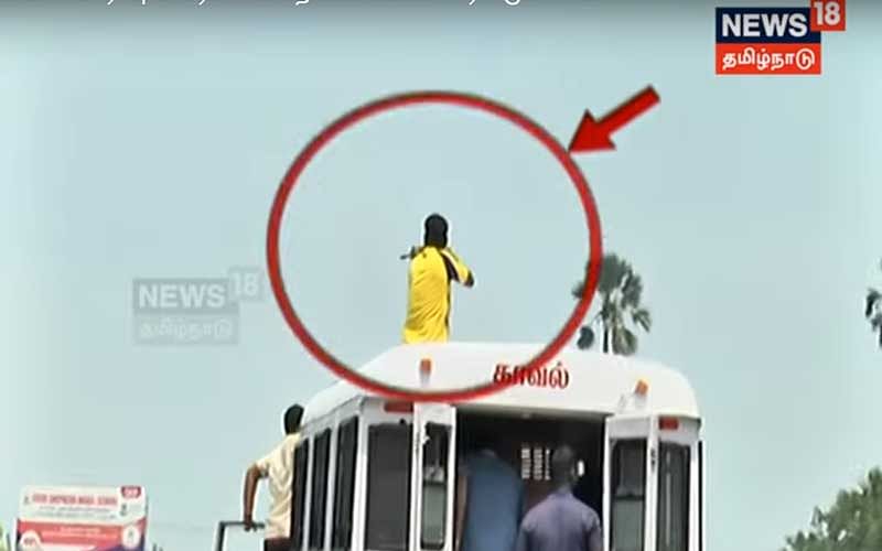 The visuals show the policemen climbing atop the vehicle of the Thoothukudi District Police and aiming at the protesters. Image: TV grab New18 Tamil Nadu