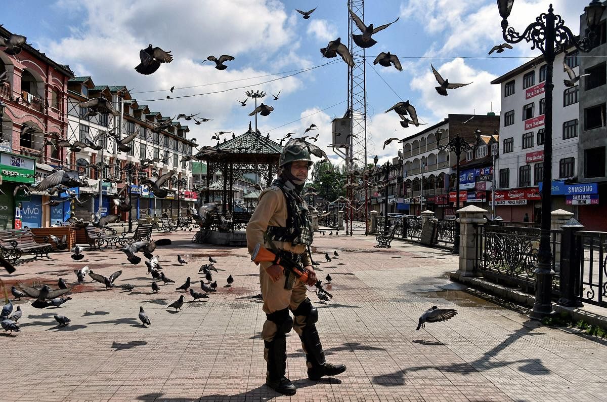 A security person stands guard during restrictions and strike called by separatists against Prime Minister Narendra Modi's visit to the state. PTI file photo.