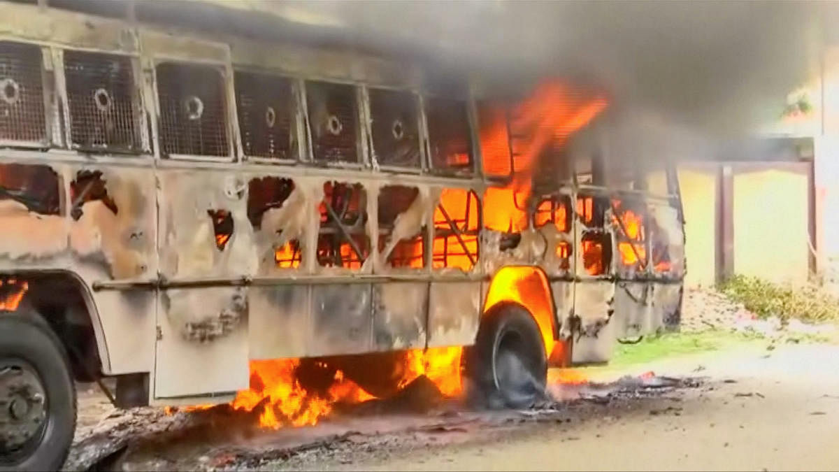 A bus on fire is seen during a protest against the construction of a copper smelter by Vedanta Resources, in Thoothukudi, Tamil Nadu, on Wednesday. ANI via REUTERS