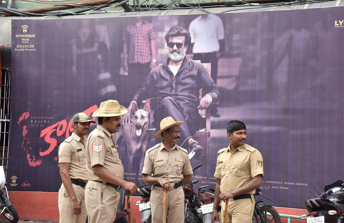 Police personnel stand guard outside the Rex Theatre, Brigade Road, where Kaala was released on Thursday. DH Photo/B K Janardhan