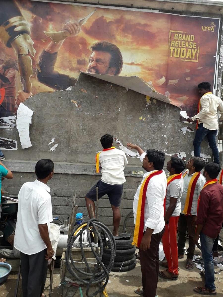 Kannada activists tear up a poster of 'Kaala' film at Sangameshwar theatre in Sindhanur, Raichur district on Thursday. dh photo