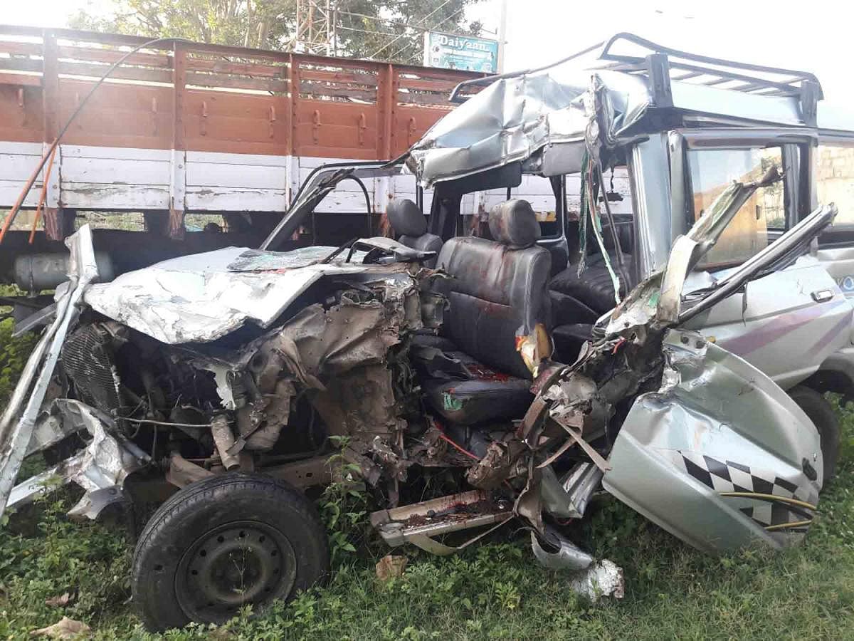 The mangled remains of the MUV which crashed into a stationary lorry on National Highway 4 near Hiriyur in Chitradurga district in the early hours of Wednesday.