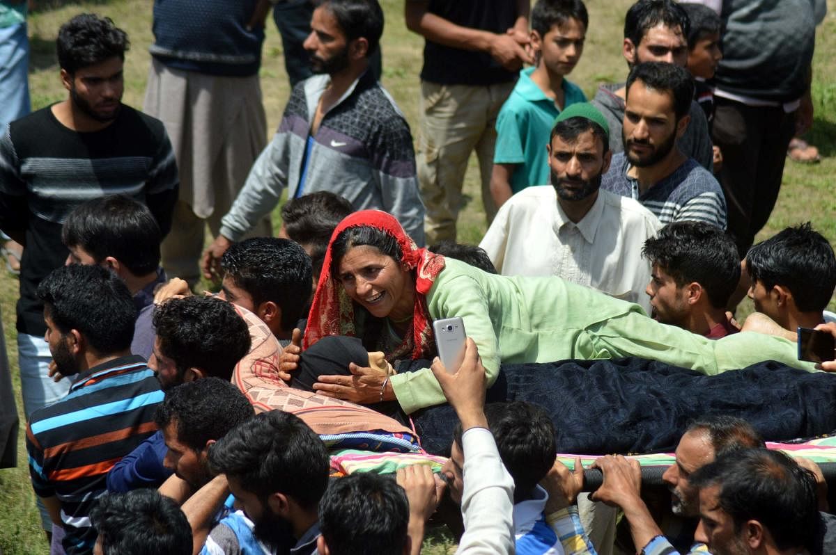 A woman wails during the funeral of 12-year-old Andleeb Ali, who was killed in army firing on July 7, in Hawoora near Kulgam in Kashmir.