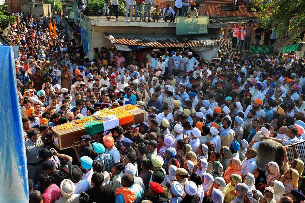The mortal remains of Rifleman Vikram Jit Singh, who was killed while foiling an infiltration bid in Jammu and Kashmir, being brought to his native village of Tepla for his last rites, in Ambala on Thursday. PTI