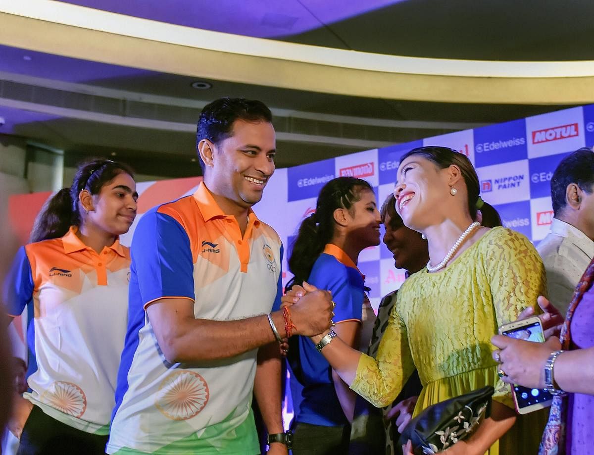 Shooter Sanjeev Rajpt and boxer Mary Kom during the Asian Games 2018 send-off ceremony in New Delhi on Friday. PTI