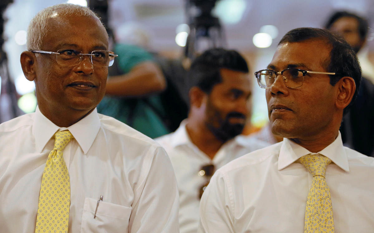 Maldivian joint opposition presidential candidate Ibrahim Mohamed Solih (left) looks on next to Maldives' former president Mohamed Nasheed at a campaign for the September 23 Presidential election where thousands of eligible Maldivians live, in Colombo, Sr