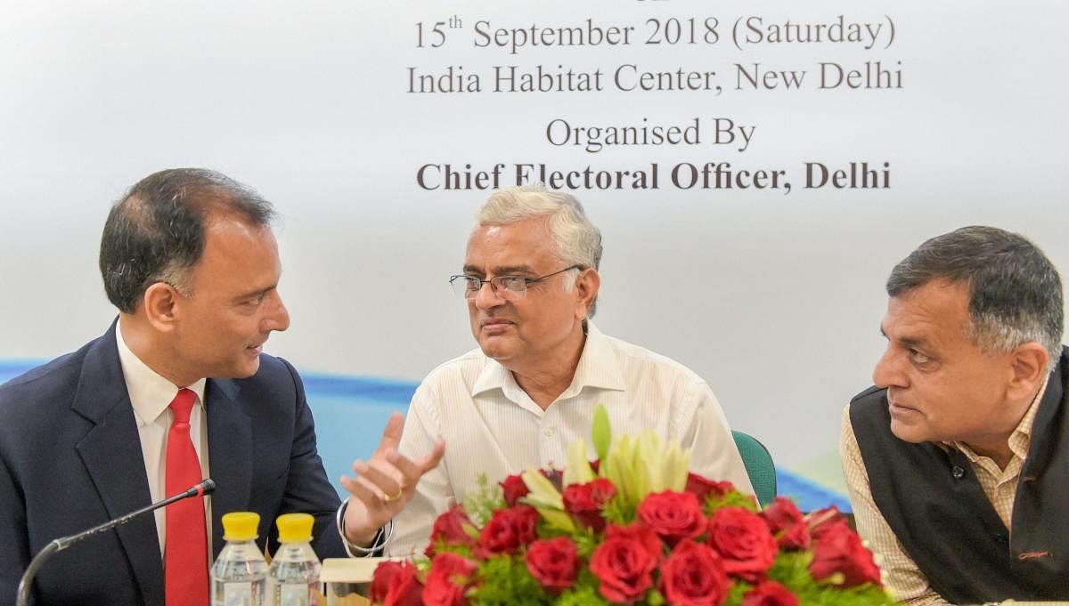 Chief Election Commissioner O P Rawat, Election Commissioner Ashok Lavasa (R) and Chief Electoral Officer Delhi Vijay Dev (L) during a symposium on 'International Day of Democracy' in New Delhi on Saturday. PTI