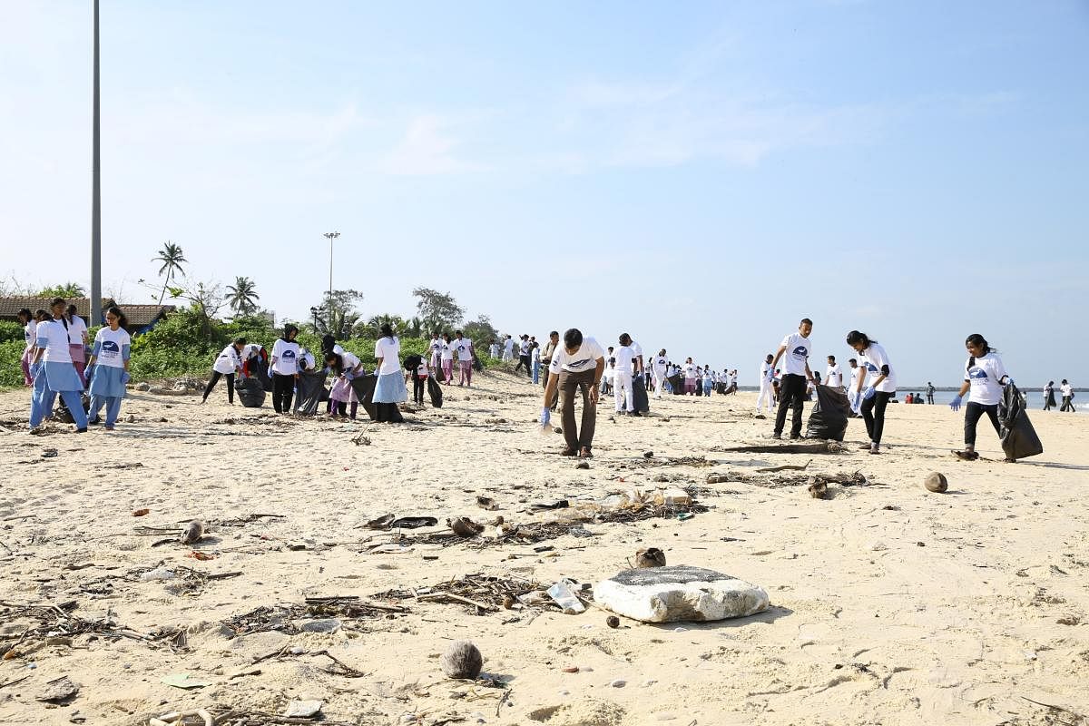 Volunteers take part in a coastal cleanup as a part of the International Coastal Cleanup organised by the Coast Guard in Mangaluru on Saturday.