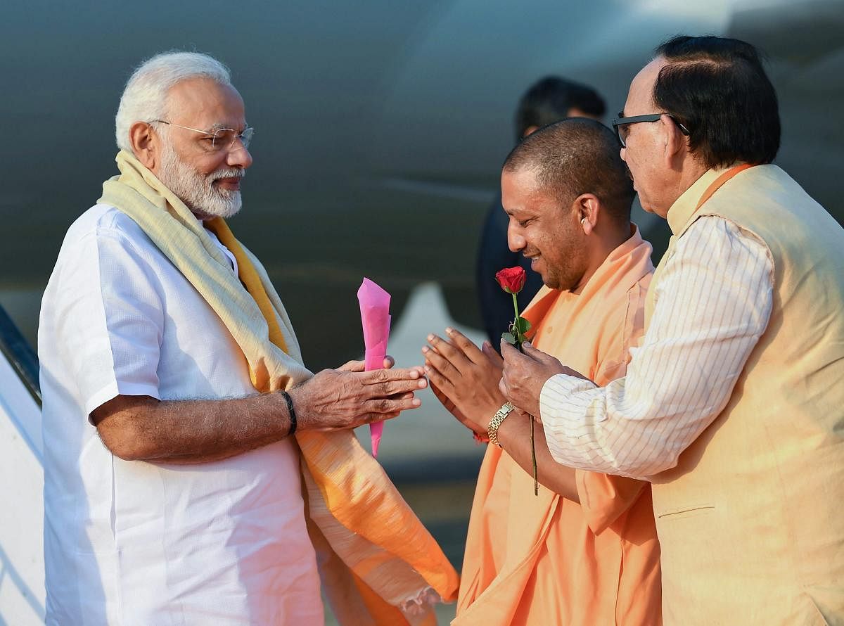 Prime Minister Narendra Modi being welcomed by the Chief Minister of Uttar Pradesh Yogi Adityanath, on his arrival in Varanasi, Uttar Pradesh, September 17, 2018. (PIB Photo via PTI) 